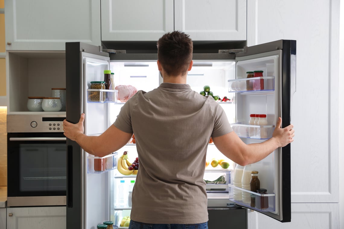 Man opening fridge