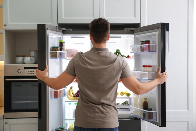 Man opening fridge